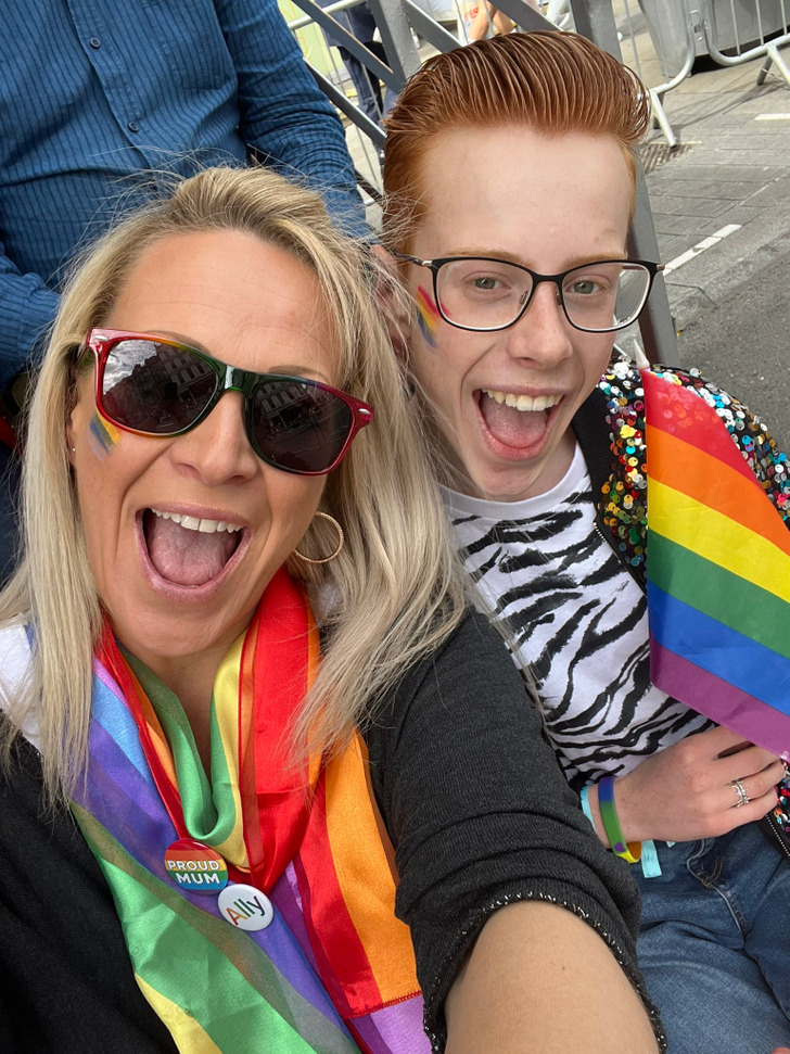 A boy and his mom at the lgbtqia+ parade.