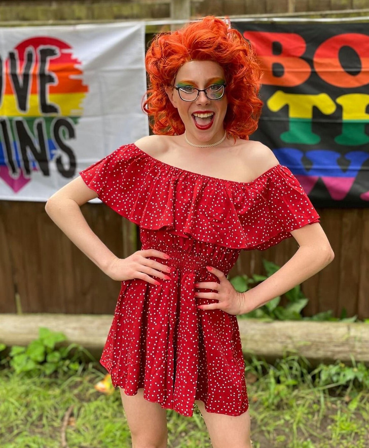 Teenage boy wearing a red dress and make-up.